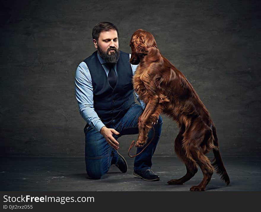 Stylish bearded middle age male and his mammals friend Irish red setter. Stylish bearded middle age male and his mammals friend Irish red setter.