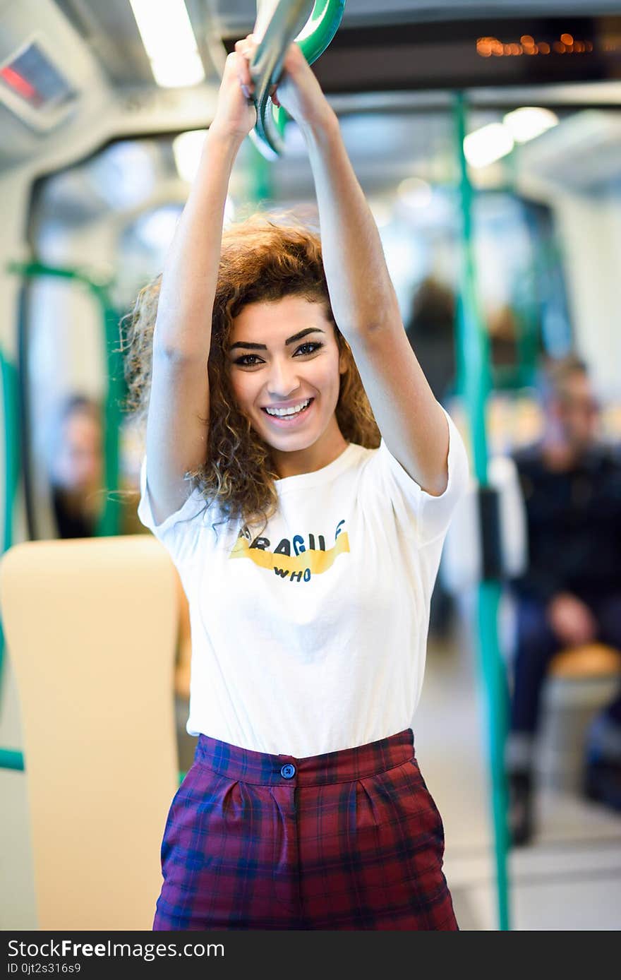 Smiling arab woman inside subway train