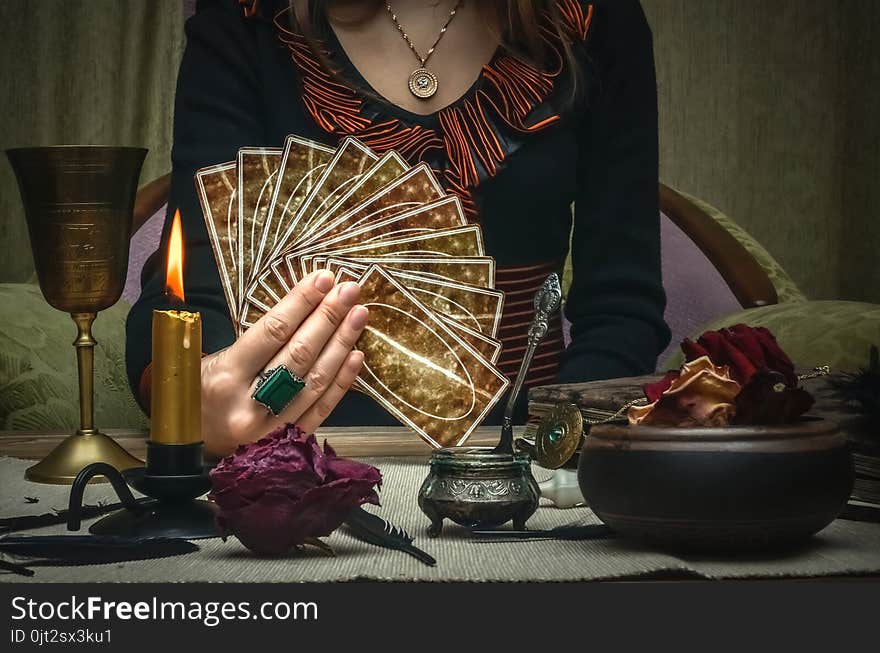 Tarot cards on fortune teller desk table. Future reading. Woman fortune teller holding and hands a deck of tarot cards. Tarot cards on fortune teller desk table. Future reading. Woman fortune teller holding and hands a deck of tarot cards.