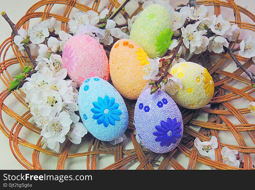 Painted Easter eggs basket and cherry tree blossom. Painted Easter eggs basket and cherry tree blossom