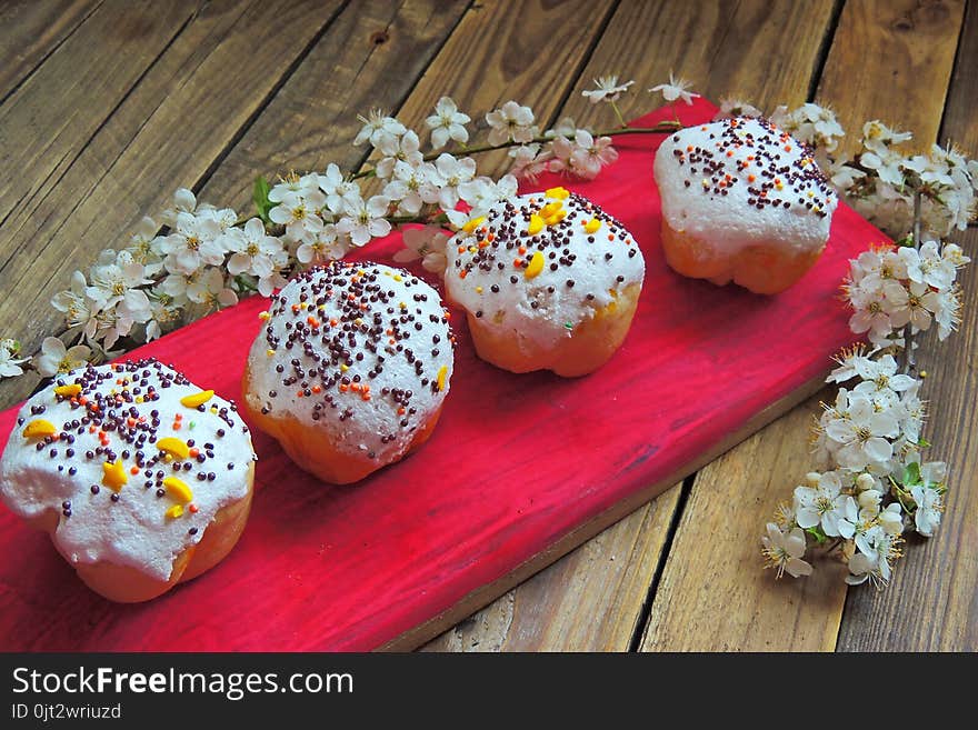 Easter colorful cupcakes on wooden table. Easter cupcakes and a cherry twig