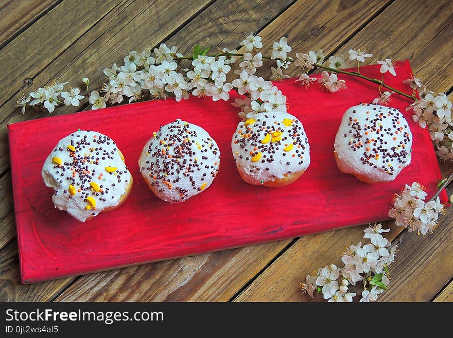 Easter colorful cupcakes on wooden table. Easter cupcakes and a cherry twig