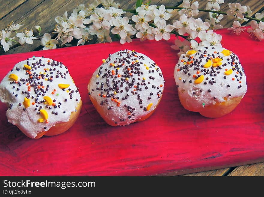 Easter colorful cupcakes on wooden table. Easter cupcakes and a cherry twig