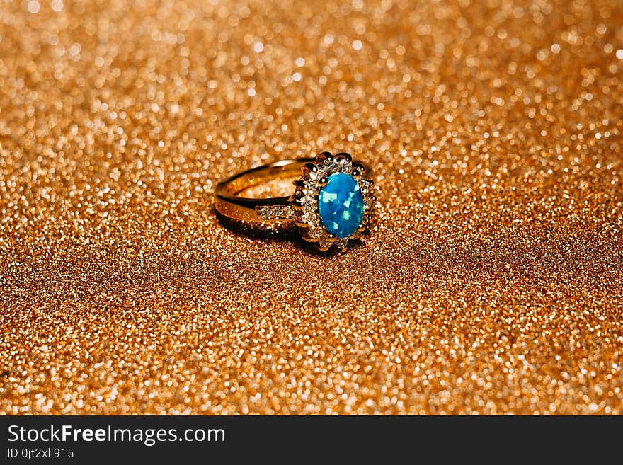 Fashion golden ring decorated with blue fire opal stones. Fashion golden ring decorated with blue fire opal stones.