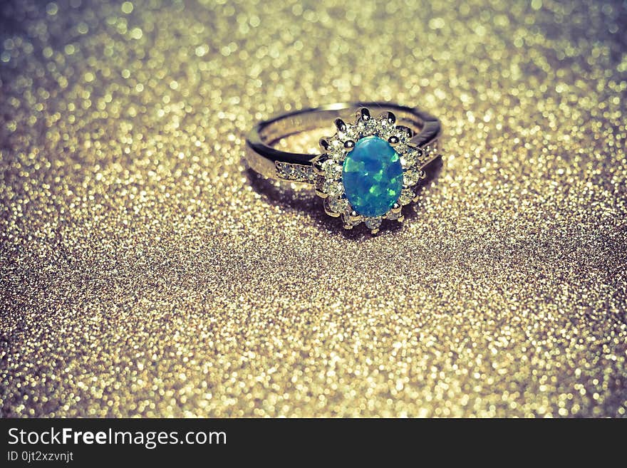 Fashion golden ring decorated with blue fire opal stones. Fashion golden ring decorated with blue fire opal stones.