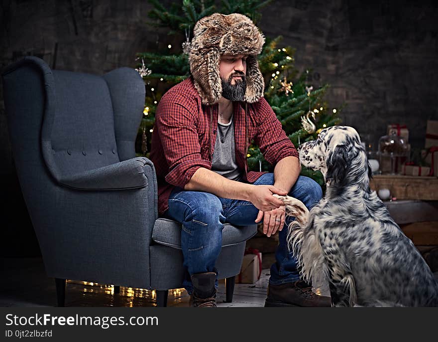 A Man In Fur Hat And Irish Setter Dog.