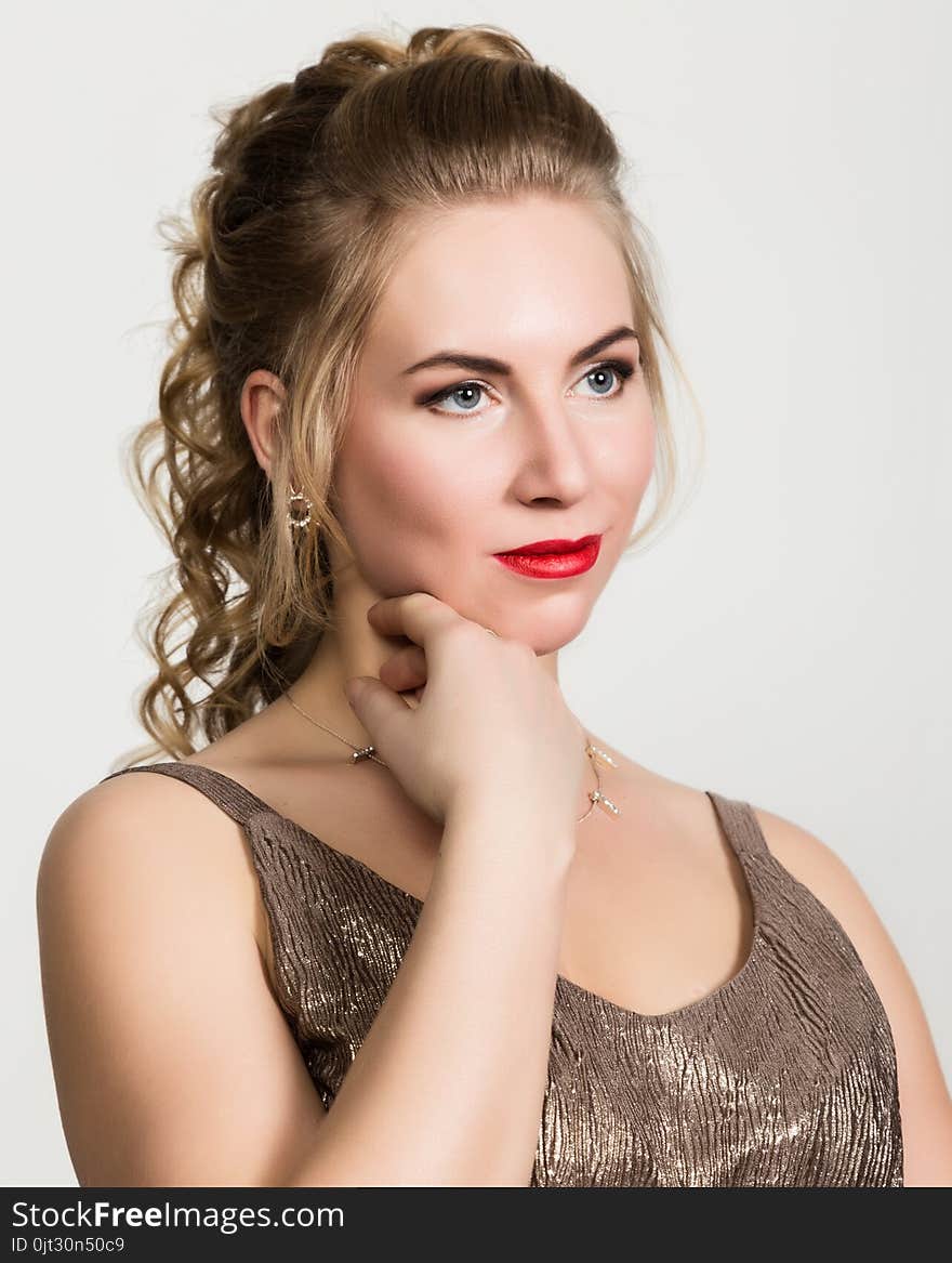 Beautiful curly woman with red lips portrait on a light background.