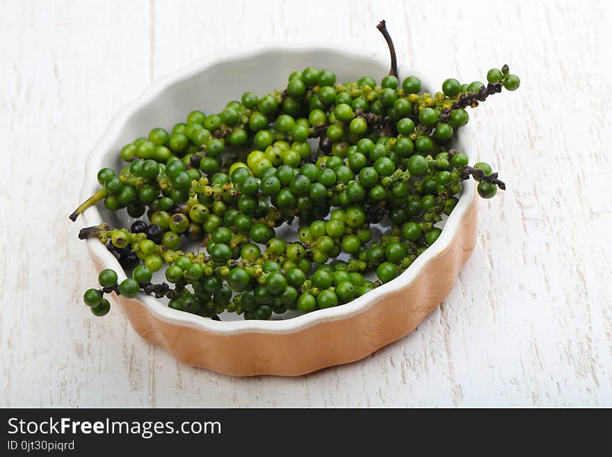 Green pepper corn on the branch in plate