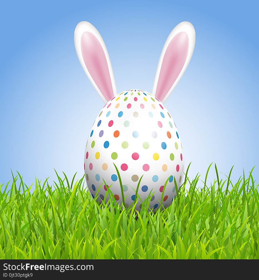 Easter background with bunny ears and egg in grass