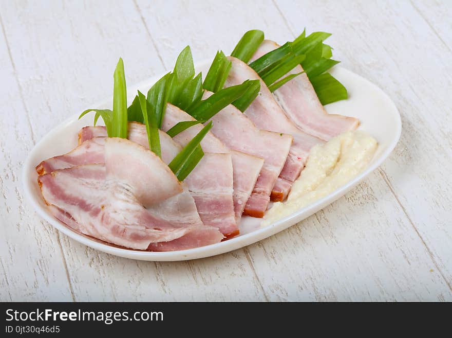 Ham with onion on the white plate