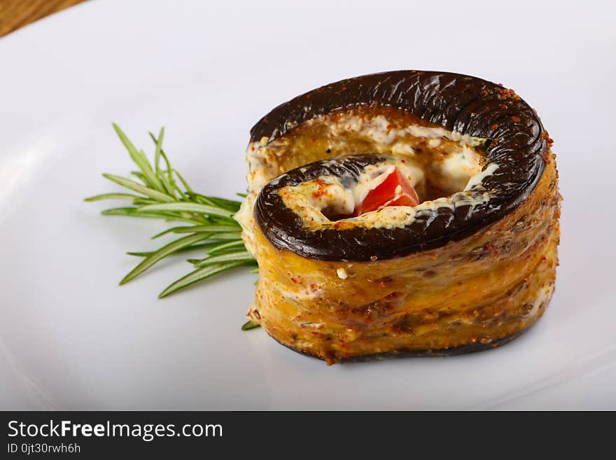 Stuffed eggplant with tomato and rosemary branch