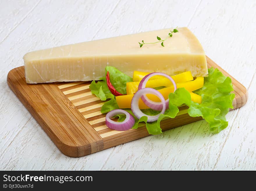 Parmesan cheese triangle on the wood background