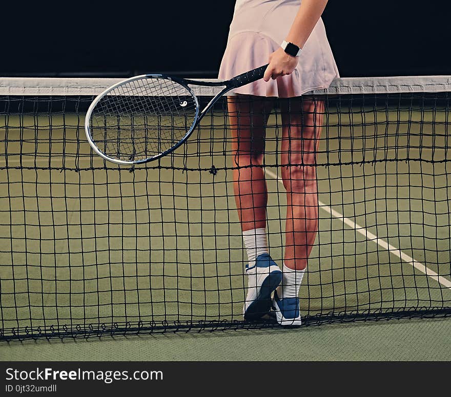 Female Tennis Player Posing On A Tennis Court.