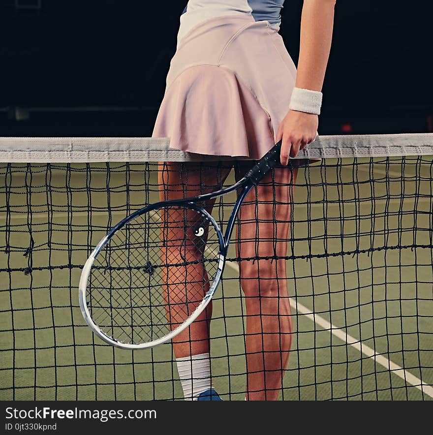 Female Tennis Player Posing On A Tennis Court.