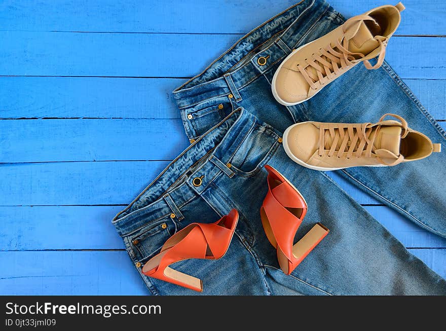 Womens clothing, footwear blue jeans, leather terracotta heel shoes, nude sneakers. Fashion outfit. Shopping concept. Flat lay. Trendy, saturated colors. Spring summer collection