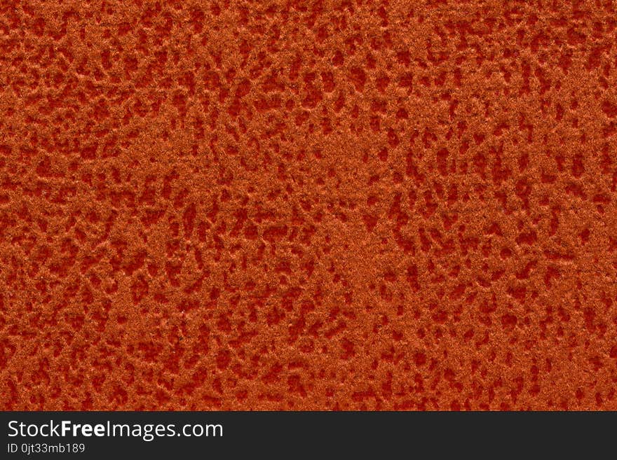 Contrast textile background in deep orange tone.