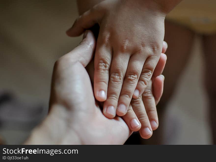 Little daughter hands in mother hands - tenderness and love. Care about each other. Little daughter hands in mother hands - tenderness and love. Care about each other.