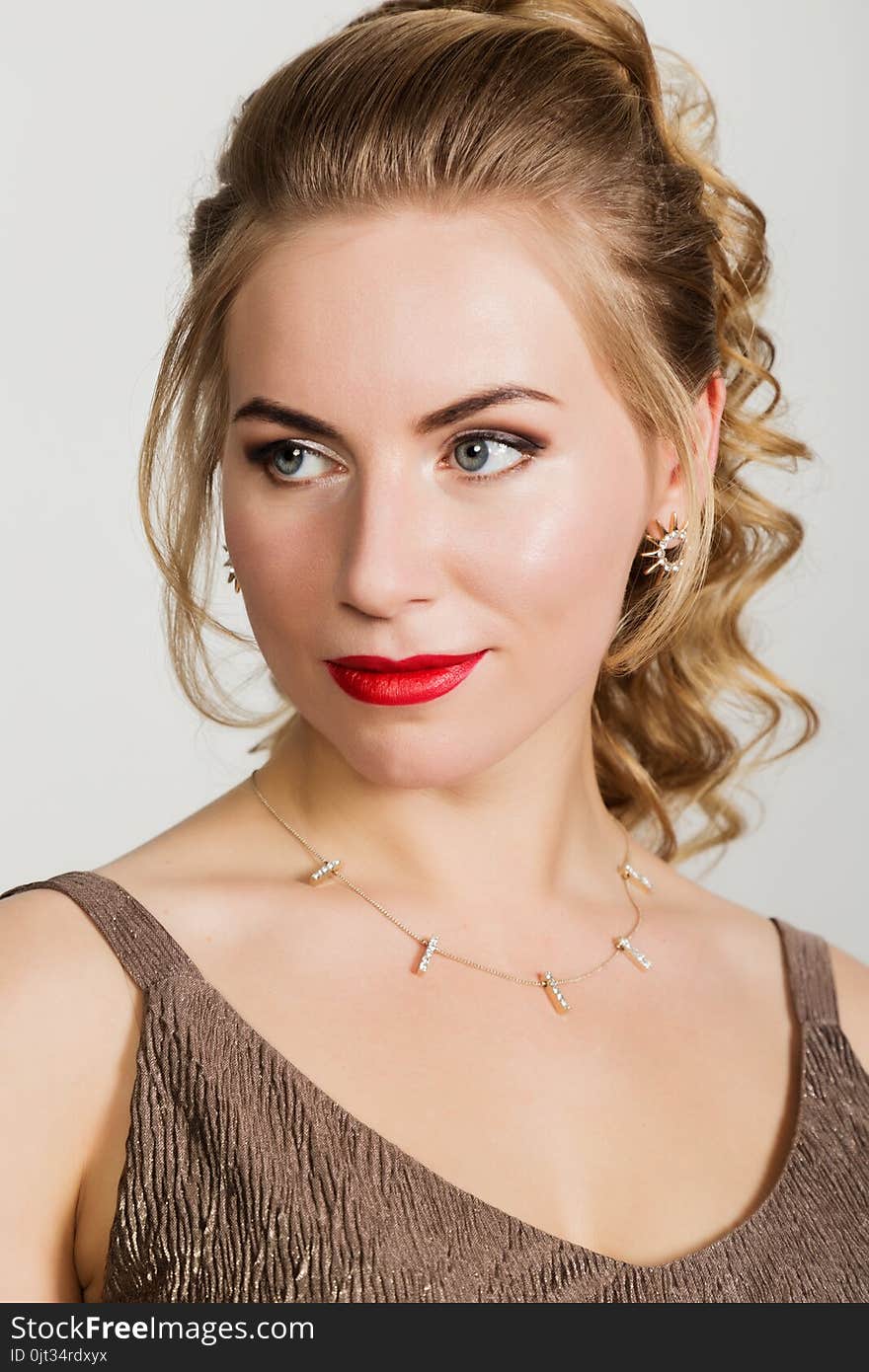 Beautiful curly woman with red lips portrait on a light background