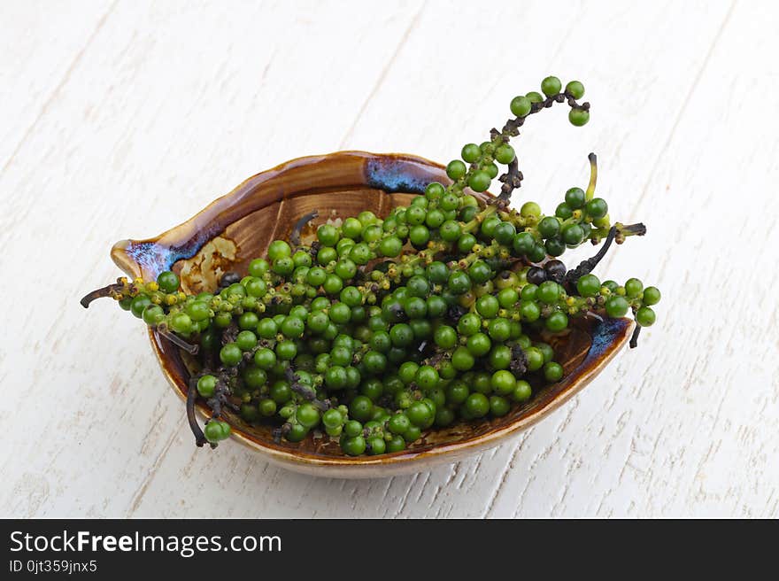 Green pepper corn on the branch in plate