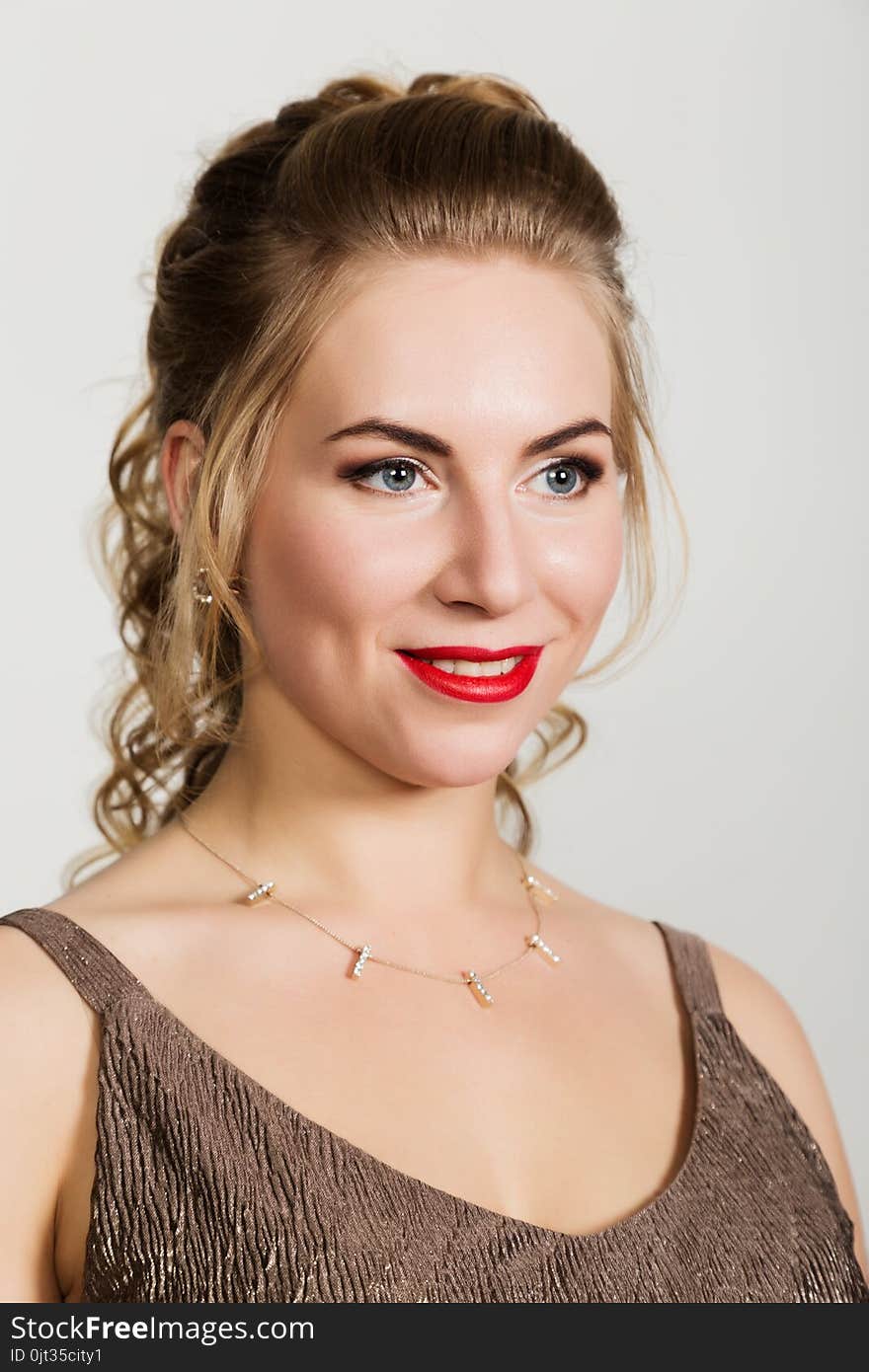 Beautiful curly woman with red lips portrait on a light background.