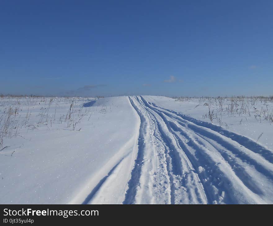 Road in the snowy field.