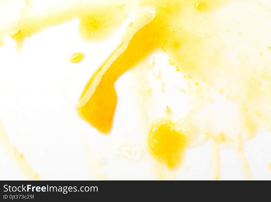 Smeared yellow jam on white.