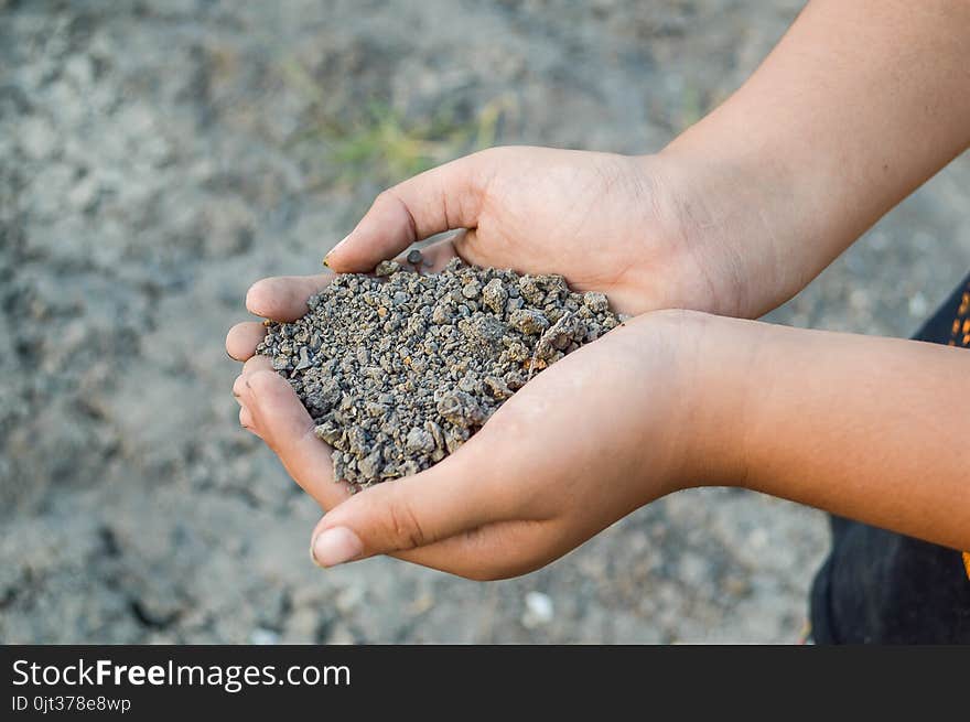 Close up dry soil on man hand