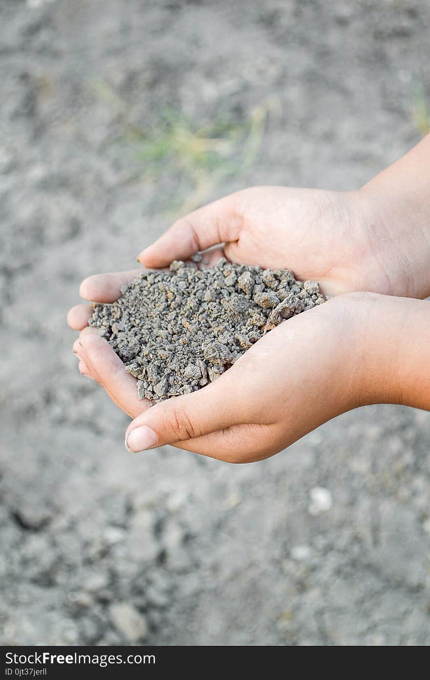 Close up dry soil on man hand