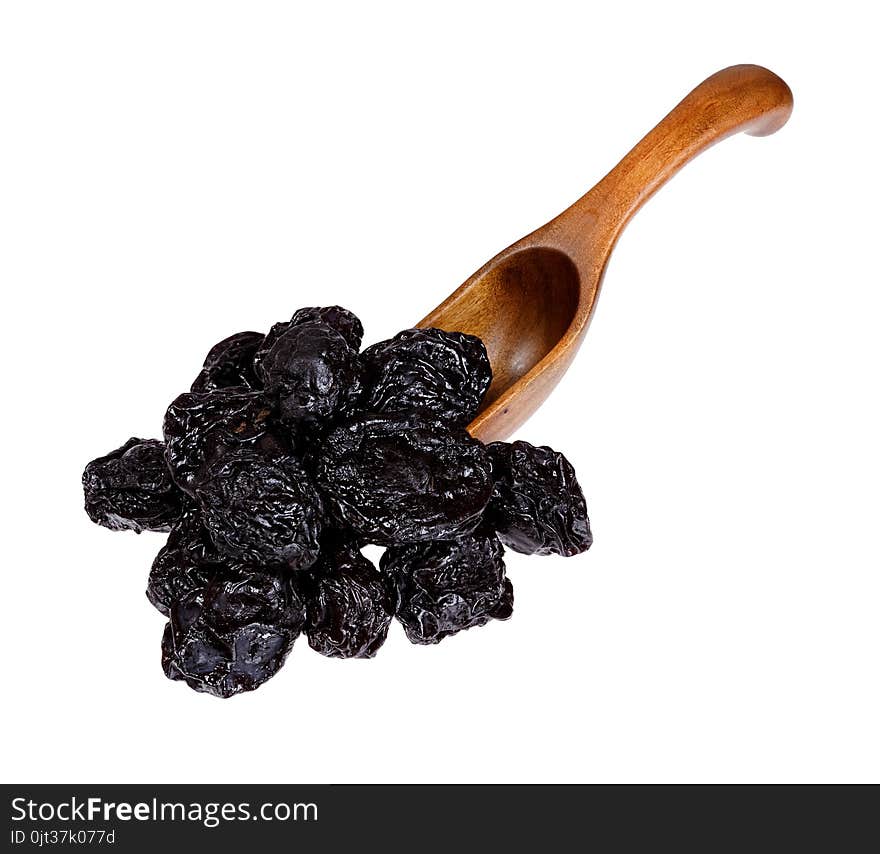 Dried Prunes in the wooden spoon, isolated on white background.