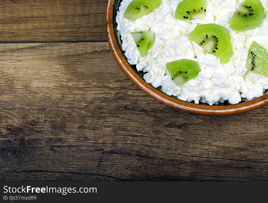 Homemade cottage cheese in a bowl on wooden table .close-up. Homemade cottage cheese in a bowl on wooden table .close-up