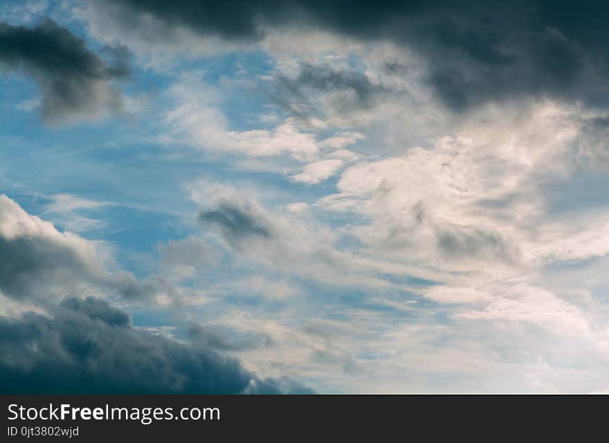 White curly clouds in a blue sky. Sky background.