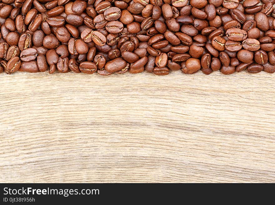 Coffee beans on old wood table. Top view.