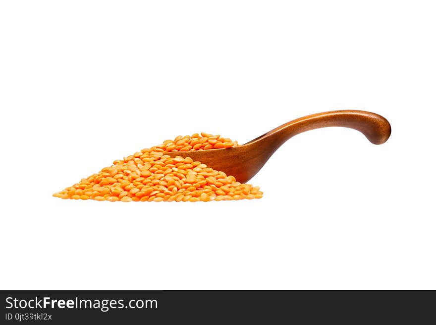 Lentils in the wooden spoon, isolated on white background. High resolution photo.