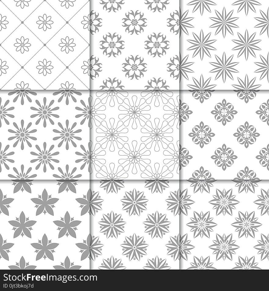 Gray and white floral ornaments. Collection of seamless patterns