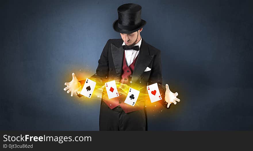 Illusionist making trick with magical play cards