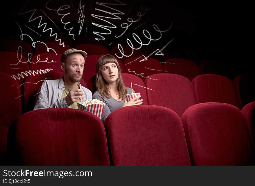 Cute couple in cinema watching movie