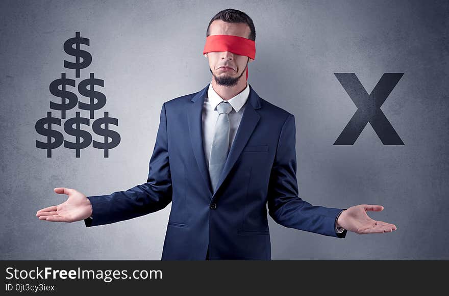 Serious businessmen standing in front of a grey wall with red ribbon on his eye, holding dollars. Serious businessmen standing in front of a grey wall with red ribbon on his eye, holding dollars