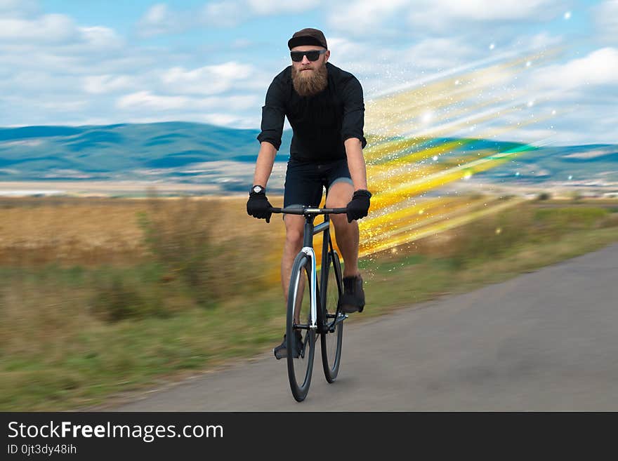 Young riding bicycle in fabulous nature with high speed. Young riding bicycle in fabulous nature with high speed