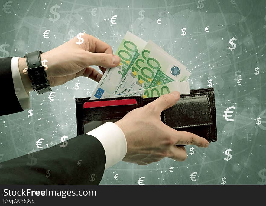 Businessman`s hand takes out euro from a wallet with global exchange graphic. Businessman`s hand takes out euro from a wallet with global exchange graphic