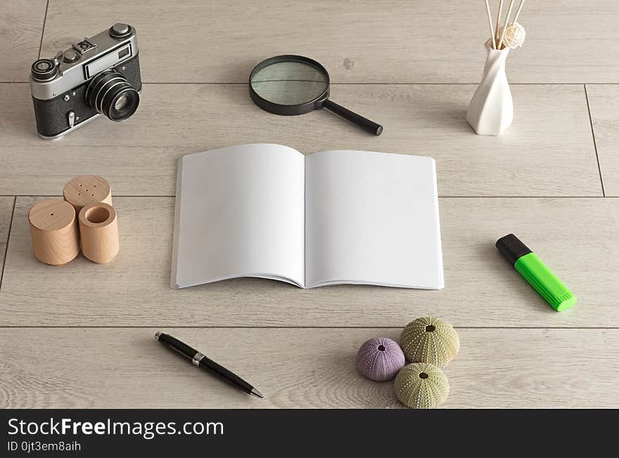 Empty notebook on wood floor with office tools nearby. Empty notebook on wood floor with office tools nearby