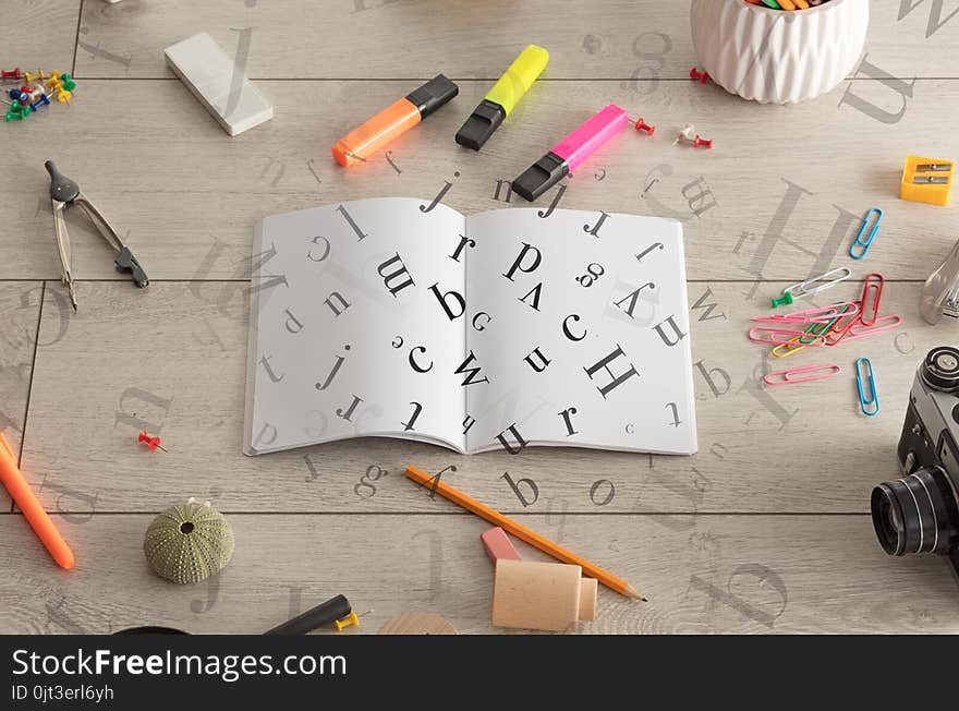 Open notebook on the floor with office instruments nearby and letters on it. Open notebook on the floor with office instruments nearby and letters on it