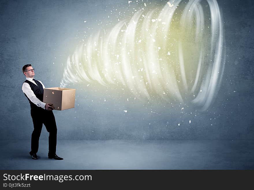 An illustrated powerful whirlwind escaping, coming out of empty paper box held by elegant businessman concept. An illustrated powerful whirlwind escaping, coming out of empty paper box held by elegant businessman concept.