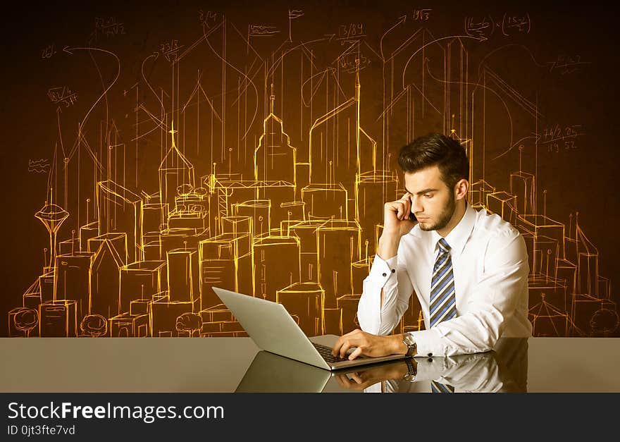 Businessman sitting at the black table with hand drawn buildings and numbers on the background. Businessman sitting at the black table with hand drawn buildings and numbers on the background