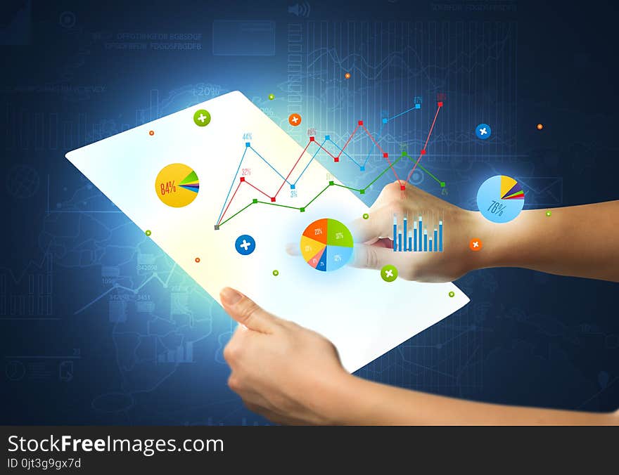 Hands Touching A Glass-like Tablet With Charts
