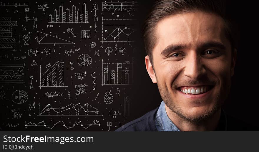 Portrait Of A Young Businessman On Dark Background