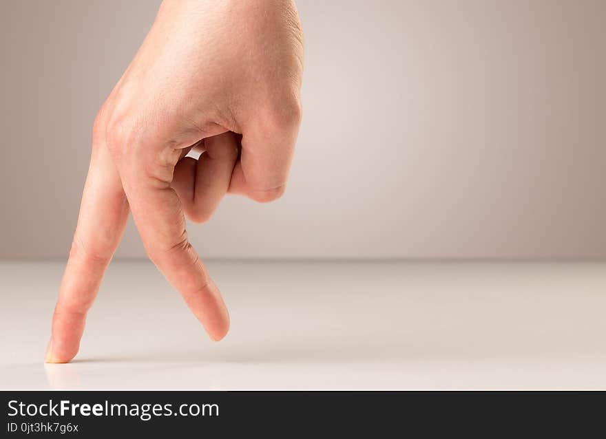 Female fingers walking on white surface. Female fingers walking on white surface