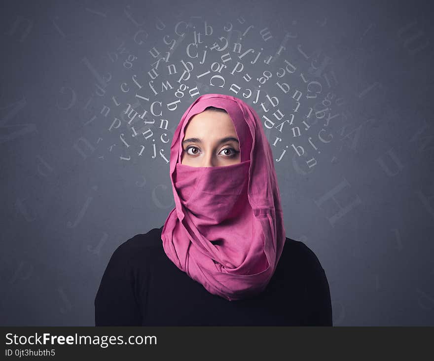 Young muslim woman wearing niqab with white alphabet letters above her head