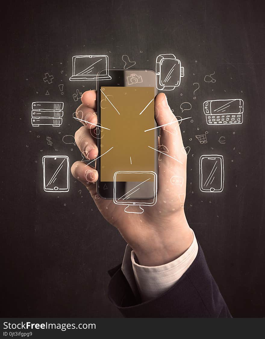 Caucasian hand in business suit holding a smartphone with hand-drawn icons. Caucasian hand in business suit holding a smartphone with hand-drawn icons