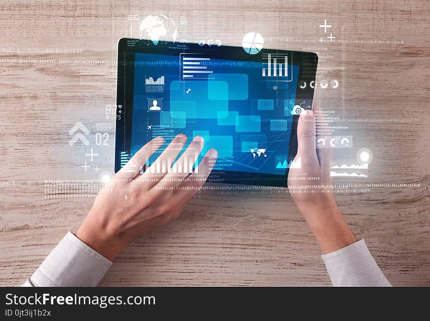 Caucasian business hands holding tablet with blue business-statistics screen. Caucasian business hands holding tablet with blue business-statistics screen