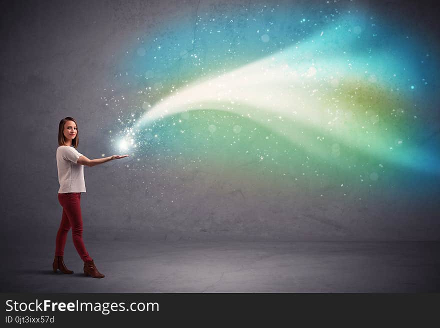 Caucasian woman holding blue, white, green coloured stria of light. Caucasian woman holding blue, white, green coloured stria of light